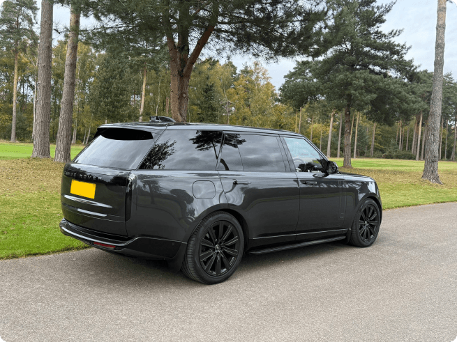 Black Range Rover parked in a park