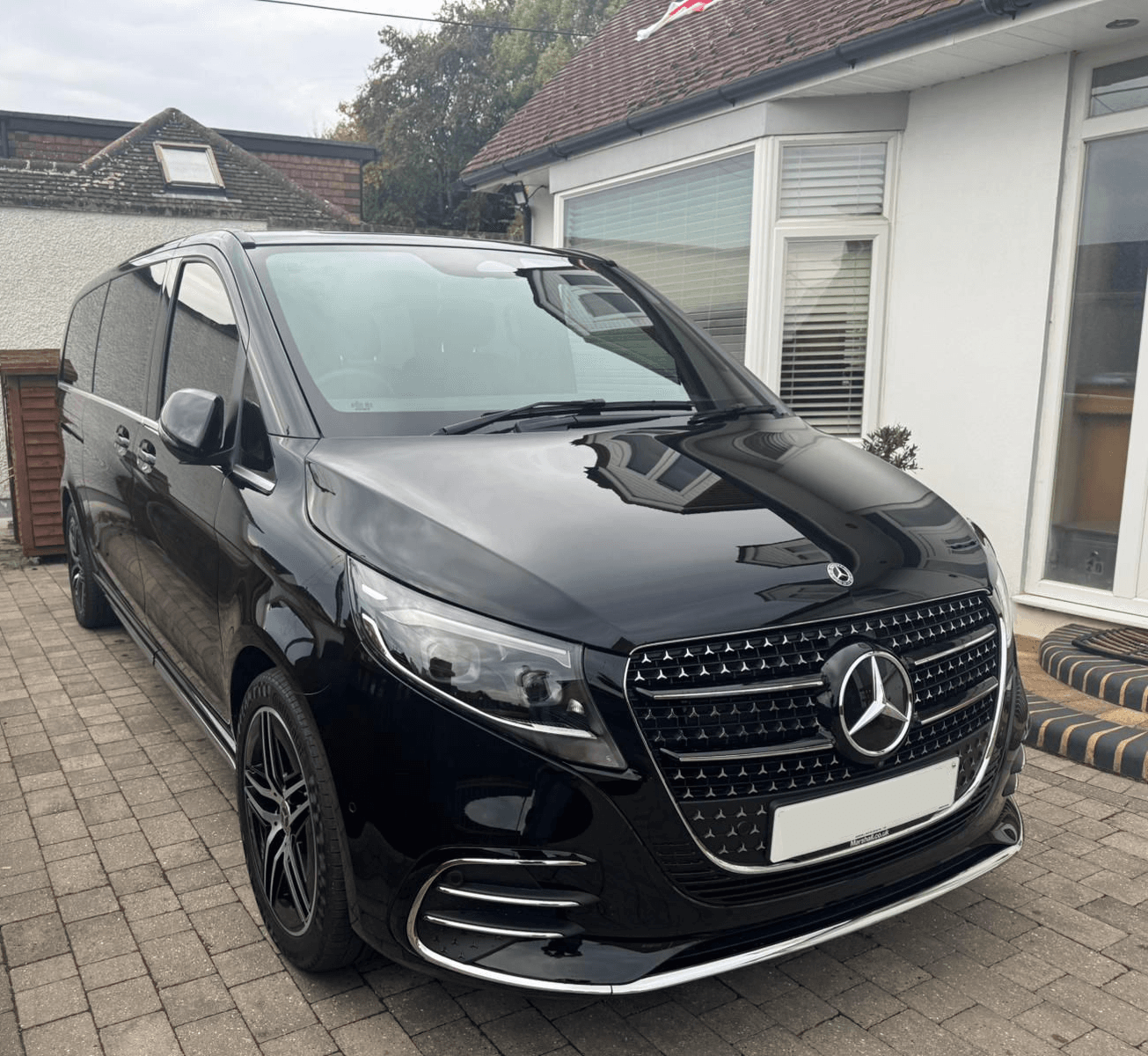 Black Mercedes-Benz V-Class parked outside a property
