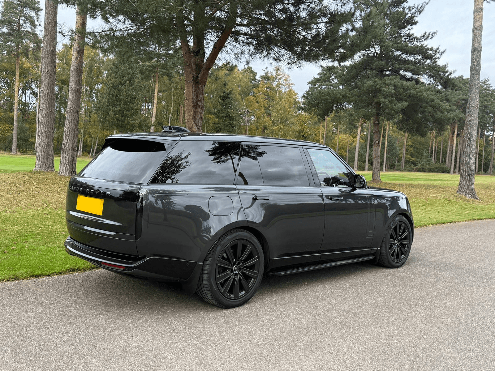 Black Range Rover parked in a park