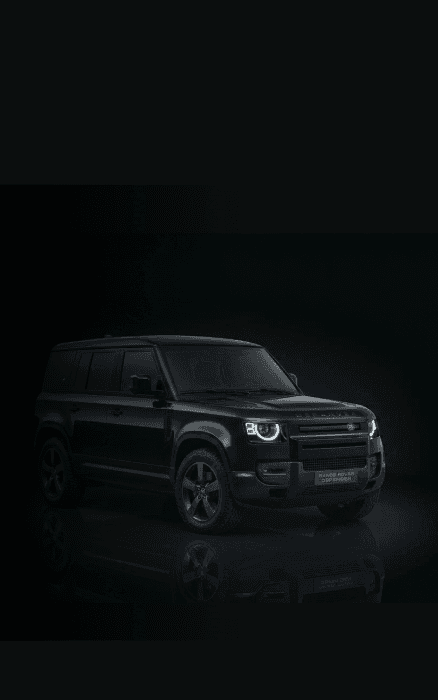 Range Rover Defender chauffeur car in a dark studio setting