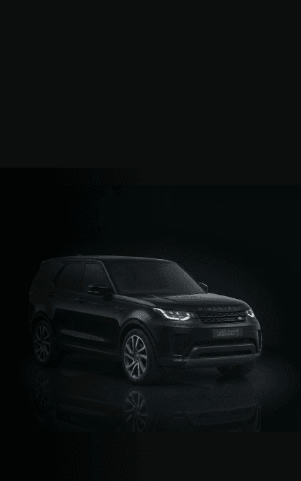 Range Rover Discovery chauffeur car in a dark studio setting